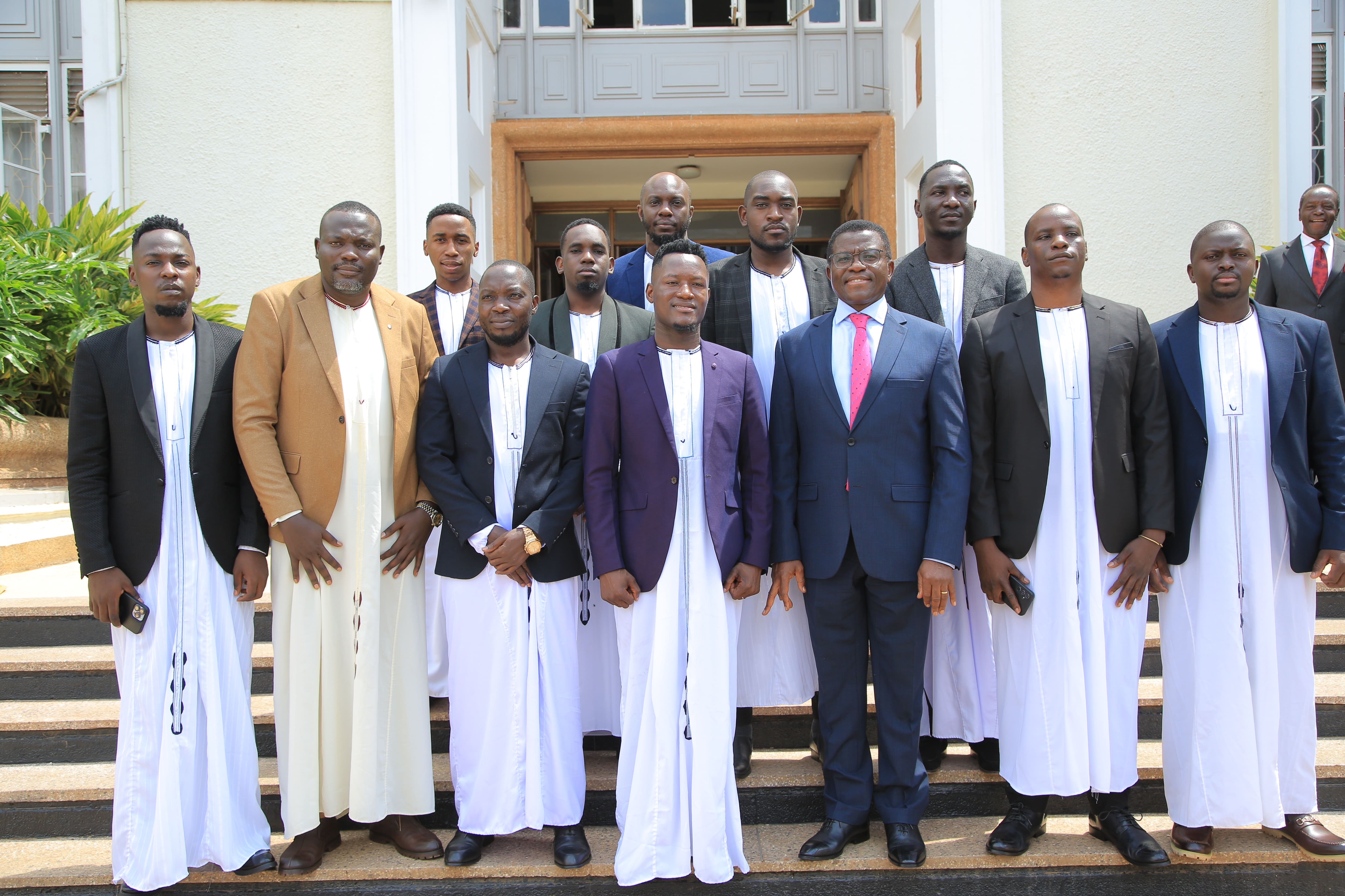 Members of the Uganda Cinematographers Association gathered outside a building in Buganda